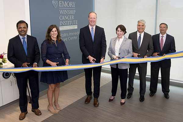 Winship and Emory leaders with members of the Rollins family cut the ribbon to inaugurate the new Rollins Immediate Care Center.